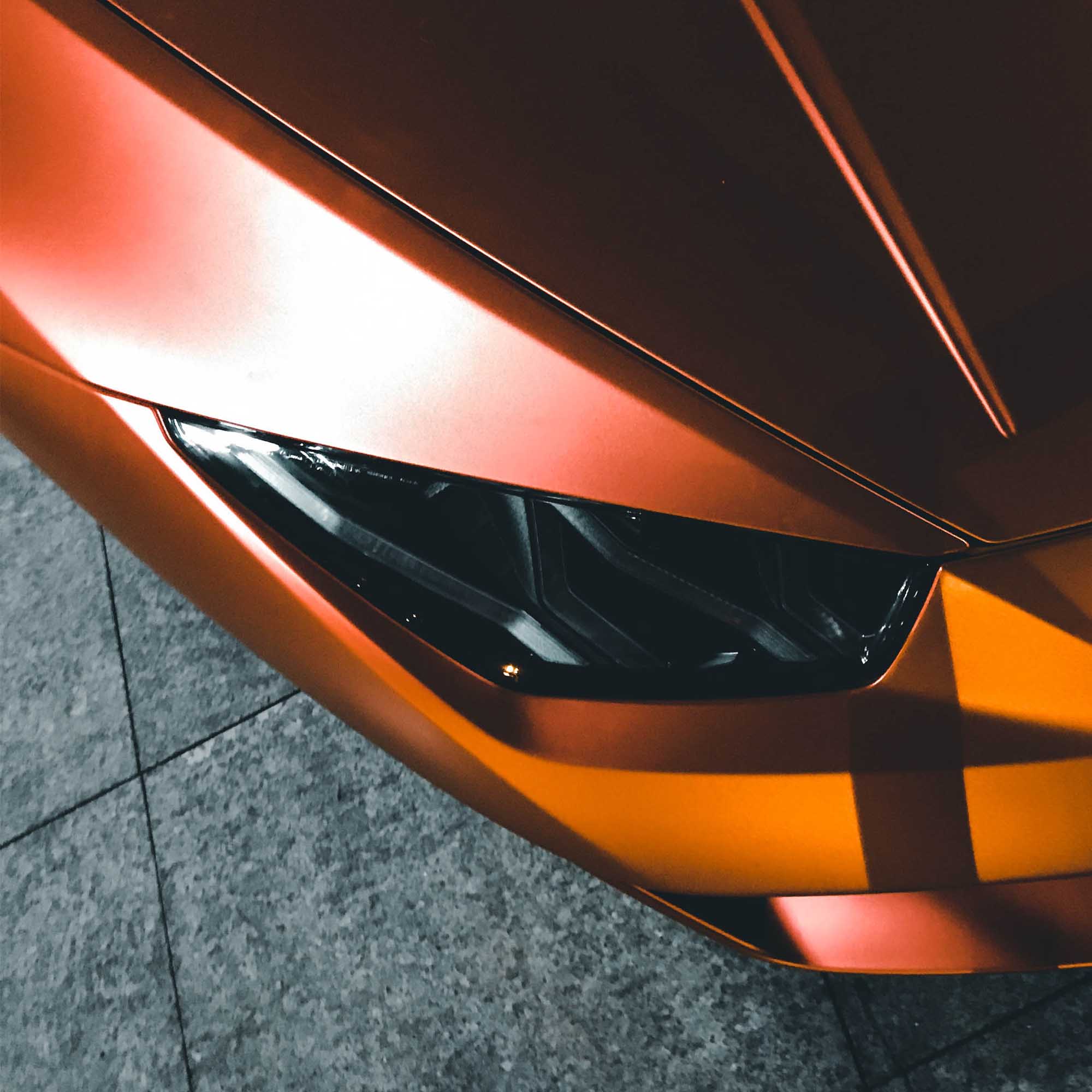 top down photo of a matte burnt orange Lamborghini headlight